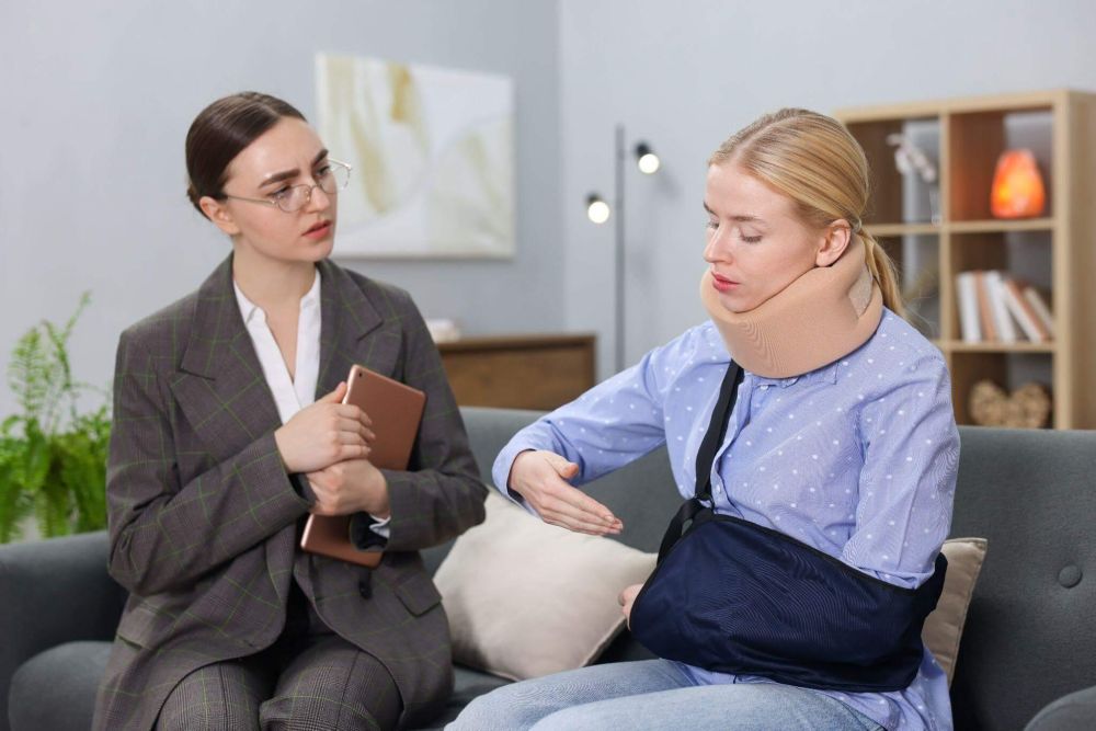 a woman sitting on a couch talking to another woman