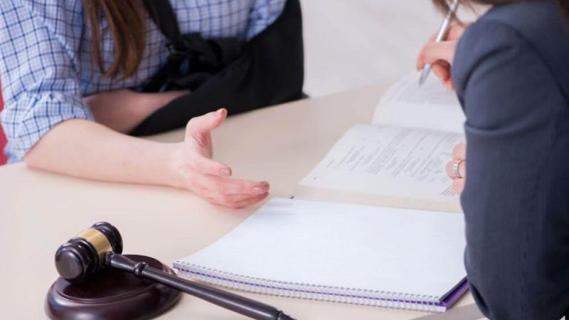 Two people reviewing papers for a truck accident lawsuit