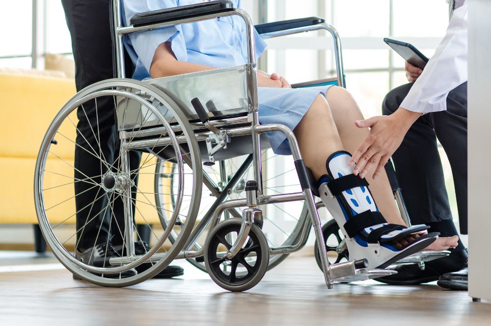 a person in a wheelchair holding the hand of another person