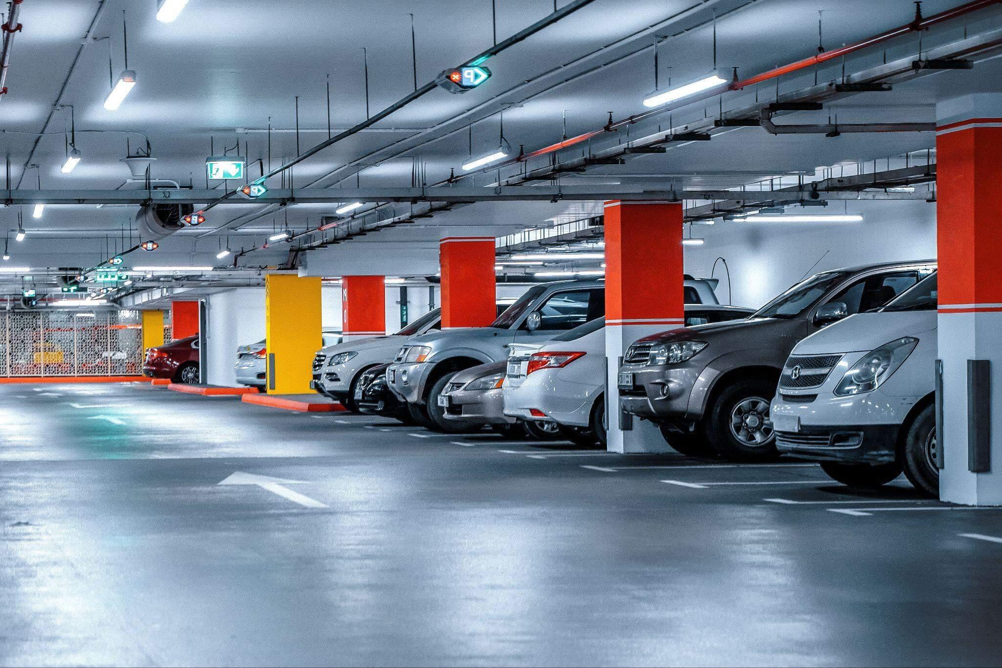 a parking garage filled with lots of parked cars